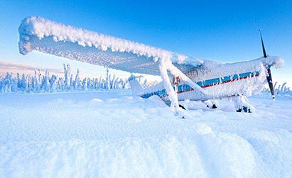 airplane covered in snow