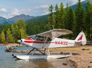 PA-18 super cub on floats at a beach