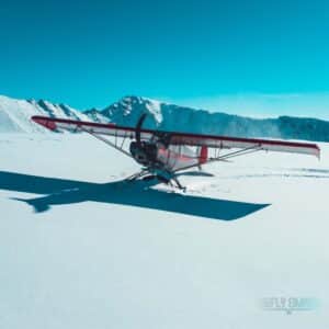 Super Cub PA-18 with skis on mountain